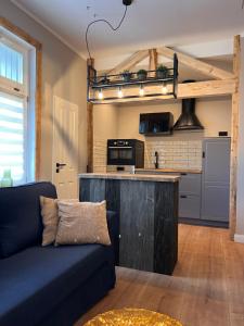 a living room with a couch and a kitchen at VILLA am Paulsberg mit Sauna - V4 in Braunlage