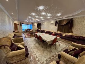 a large room with couches and a table and chairs at Villa Marmara in Medina