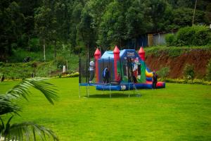 a group of people in a park with a playground at SpringWells Hotel ltd in Maua