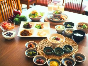 a table with plates of food and bowls of food at Osaka Joytel Hotel in Osaka
