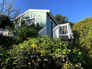 a small house with a window on the side of it at Martin's Cottage in Great Brak River