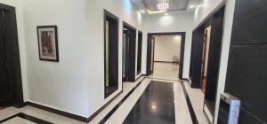 a hallway with black and white walls and black doors at Haven Lodge, Islamabad in Islamabad