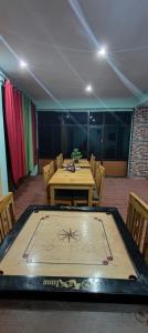 a ping pong table in the middle of a room at Dangsal Boutique Stays Ladakh by LexStays in Leh