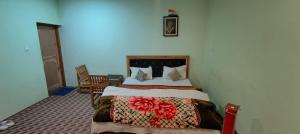 a bedroom with a bed and a chair in it at Dangsal Boutique Stays Ladakh by LexStays in Leh +45 photos