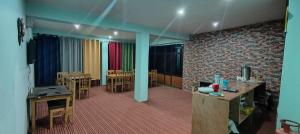 a room with tables and chairs and a brick wall at Dangsal Boutique Stays Ladakh by LexStays in Leh