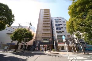 a tall building in the middle of a city at Meitetsu Inn Nagoya Kanayama Annex in Nagoya