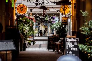 an aisle of a store with lights and plants at Quiet Luxury Apartment with 2 rooms in the City Centre BB in Budapest +7 photos