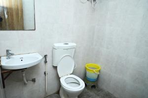 a bathroom with a toilet and a sink at Hotel Blue Leaf in Rajkot