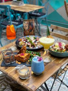 a wooden table with plates of food and drinks on it at Quiet Luxury Apartment with 2 rooms in the City Centre BB in Budapest