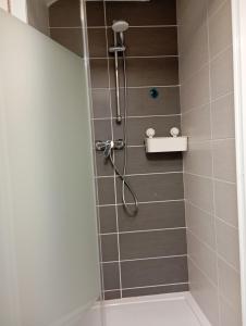 a bathroom with a shower with a glass door at Appart Maison de ville in Bourges