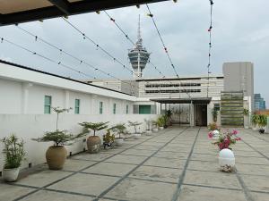 a courtyard with potted plants on a building at Fuller Hotel in Alor Setar