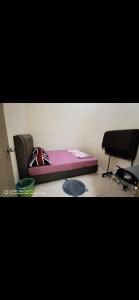 a room with a bed and a chair in it at Cahya Homestay Bukit Gambang in Gambang