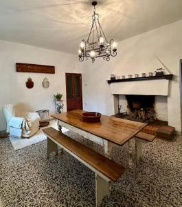 a living room with a table and a fireplace at Podere Casa Rossa a Pienza in Pienza