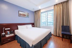 a hotel room with a large bed and a window at A25 Hotel - 63A Phương Liệt in Hanoi