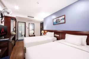 a hotel room with two beds and a desk at A25 Hotel - 63A Phương Liệt in Hanoi +19 photos