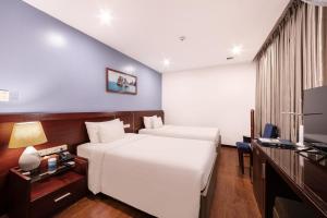a hotel room with a bed and a television at A25 Hotel - 63A Phương Liệt in Hanoi