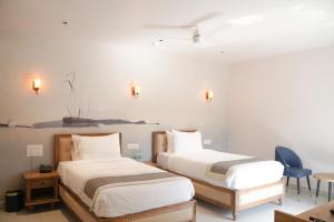 Voodi või voodid majutusasutuse Ariena by Spree Hotels Goa toas