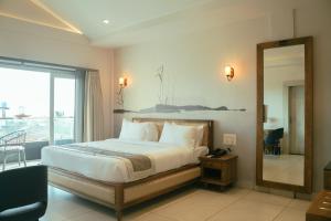 Voodi või voodid majutusasutuse Ariena by Spree Hotels Goa toas