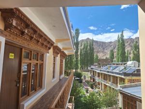 a view of the mountains from the balcony of a building at Green Villa Guest House Ladakh by LexStays in Leh