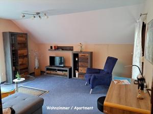 a living room with a couch and a tv at Haus Sonneneck in Bad Bocklet