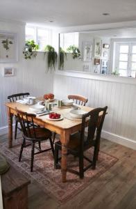 a dining room table with chairs and a wooden tableablish at Earl Cottage, Woodbridge in Woodbridge