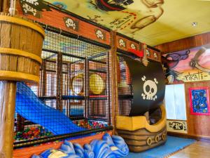 a childs play room with a pirate ship and a slide at Family Hotel Alexander in Lido di Jesolo