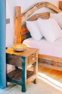 a bedroom with a bed and a table with a basket on it at Limiria Residence in Nungwi
