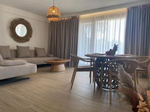 a living room with a couch and a dining room table at Filoxenia Sea View in Parga