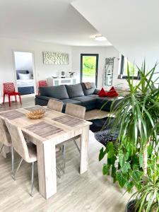 a living room with a table and a couch at LUX Ferienwohnungen in Hepbach