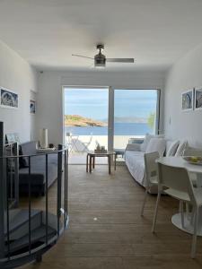 a living room with a bed and a view of the ocean at Seaside Lavrio Beach House in Sounio