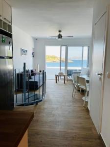 a kitchen and dining room with a view of the ocean at Seaside Lavrio Beach House in Sounio