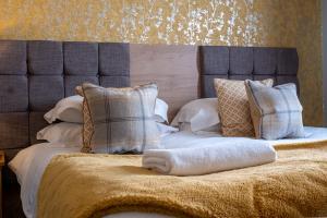 a bed with pillows and a blanket on it at The Upper Largo Hotel & Restaurant in Lundin Links