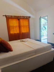 a bed in a room with a window at Villa Kalachuchi V.K in Puerto Princesa City +47 photos