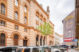 a large building with cars parked in front of it at Quiet Luxury Apartment with 2 rooms in the City Centre BB in Budapest