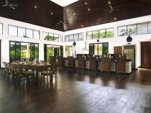a large dining room with a table and chairs at Villa Galanga 3 Bedrooms Plus Cottage Room in Ao Nang Beach
