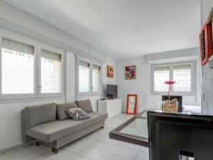 a living room with a couch and a tv at Los Globos Beach Studio by Hello Homes Sitges in Sitges +11 photos