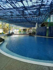 a large pool of blue water in a building at Chill Spot Staycation in Pasig in Manila