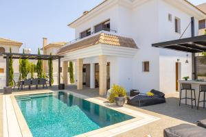 a villa with a swimming pool and a house at SunnyVillas-3BR New Modern Villa-Private Pool-HVN in Paralimni