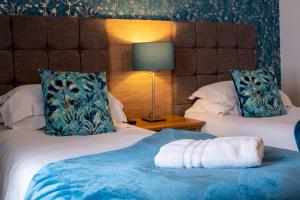a hotel room with two beds with a towel on the bed at The Upper Largo Hotel & Restaurant in Lundin Links