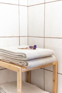 a stack of towels on a wooden platform in a bathroom at PodLaskiem SLEEP & SPA in Ateny +44 photos
