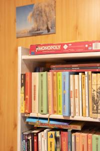 a book shelf filled with lots of books at PodLaskiem SLEEP & SPA in Ateny