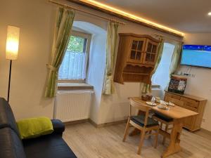 a living room with a table and a couch at Wandlhof Ferienwohnung 3971 Sankt Martin in Zeil