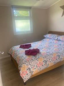 a bedroom with a bed with two towels on it at Caban Cynnes- The Cosy Cabin, Holiday let, near Mansion House, Llansteffan in Llanstephan +11 photos