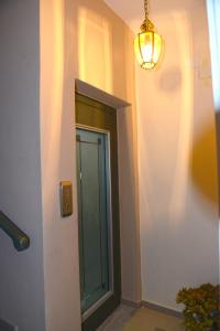 a hallway with a glass door and a light at Preveza Palazzo in Preveza +31 photos