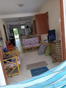 a living room with couches and a laptop on a table at Maria José de Oliveira Barreto in Camaçari