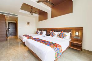 Postel nebo postele na pokoji v ubytování FabHotel Prime Nestlay Rooms Ramnad - Nr Golden Shopping Mall
