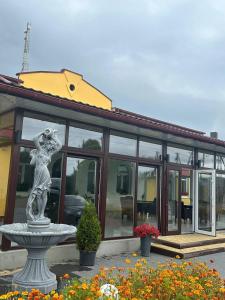 a statue in front of a building with windows at SN Family in Radekhov +31 photos