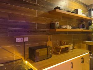 a kitchen with a microwave sitting on a counter at Bohemian Suite in Accra