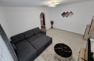 a living room with a couch and a table at Apartament Ultracentral Suceava in Suceava