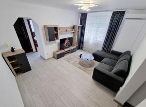 a living room with a couch and a fireplace at Apartament Ultracentral Suceava in Suceava